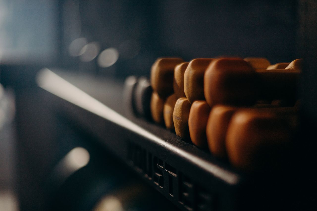 A rack of dumbbells in a dimly lit gym, highlighting fitness equipment.